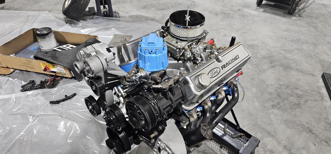 A rebuilt V8 on an engine stand with polished covers